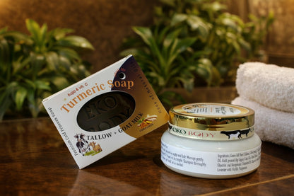 Turmeric soap bar and jar on a wooden surface with plants in the background