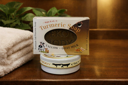Eko Body Turmeric Soap packaging on a wooden surface with a towel and plant in the background