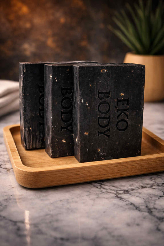 Three bars of Eko Body soap on a wooden tray with a marble background