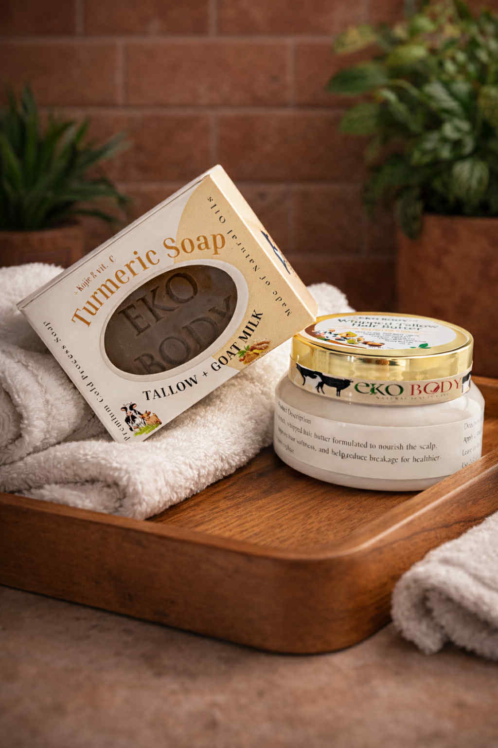 Eko Body products including a jar and soap on a wooden tray with a towel and plants in the background.